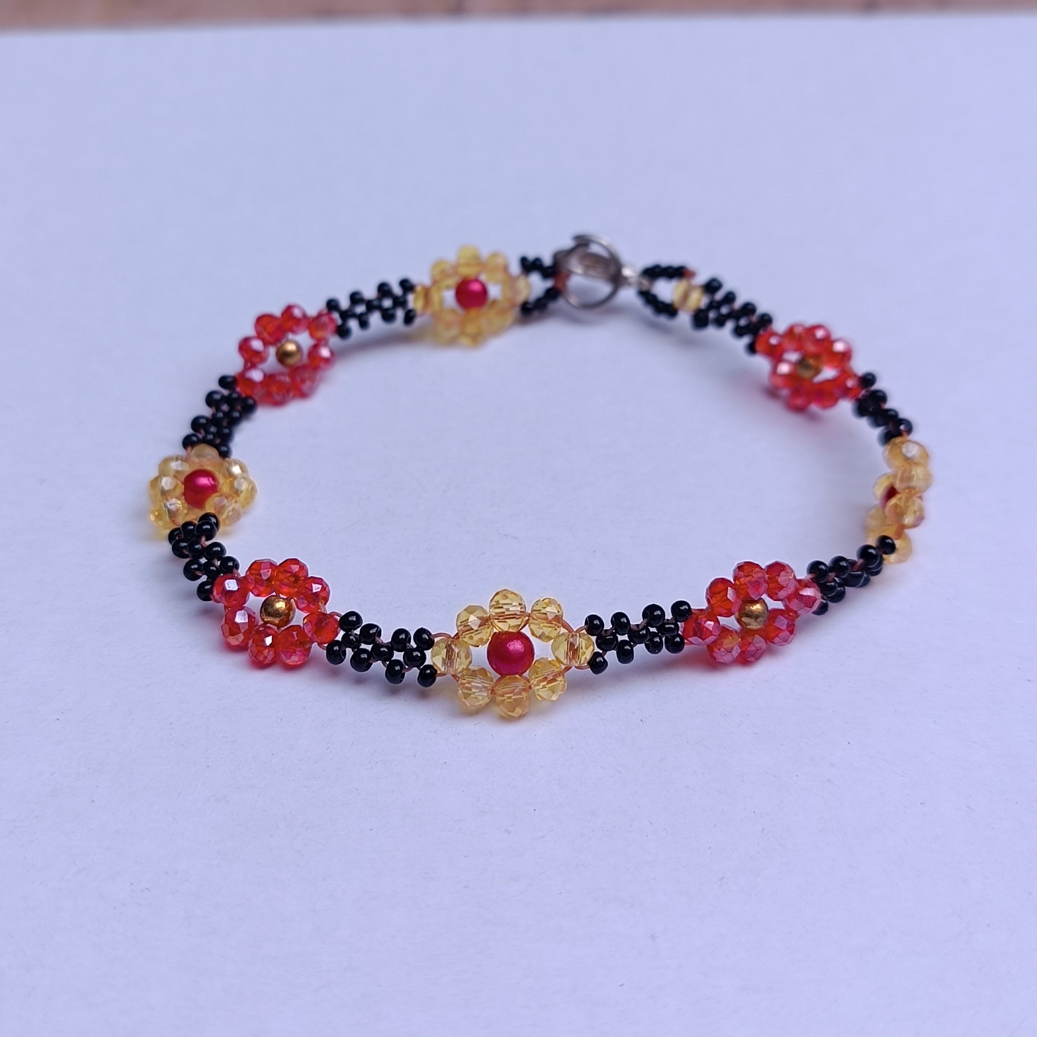 Handmade Black Seed-Bead Bracelet with Red & Yellow Flower Accents